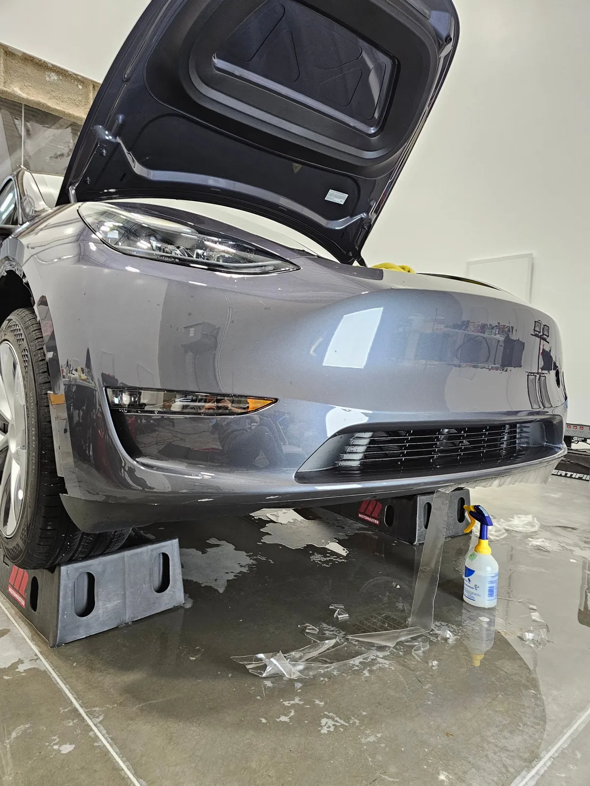 Grey Tesla Model Y front bumper wrapped in a single piece of film.